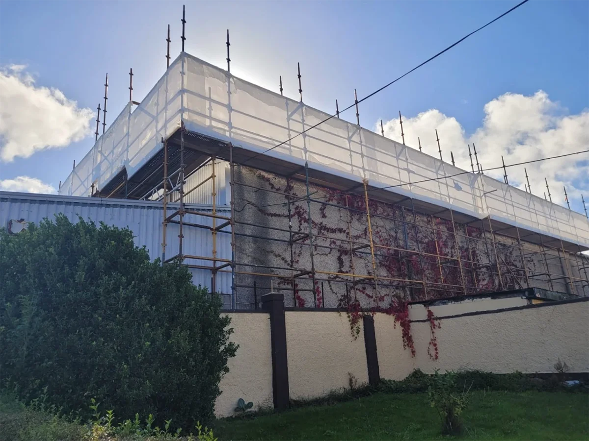 Professional asbestos removal preparation at Irish residential property - HSA licensed specialists in full PPE equipment setting up containment zone